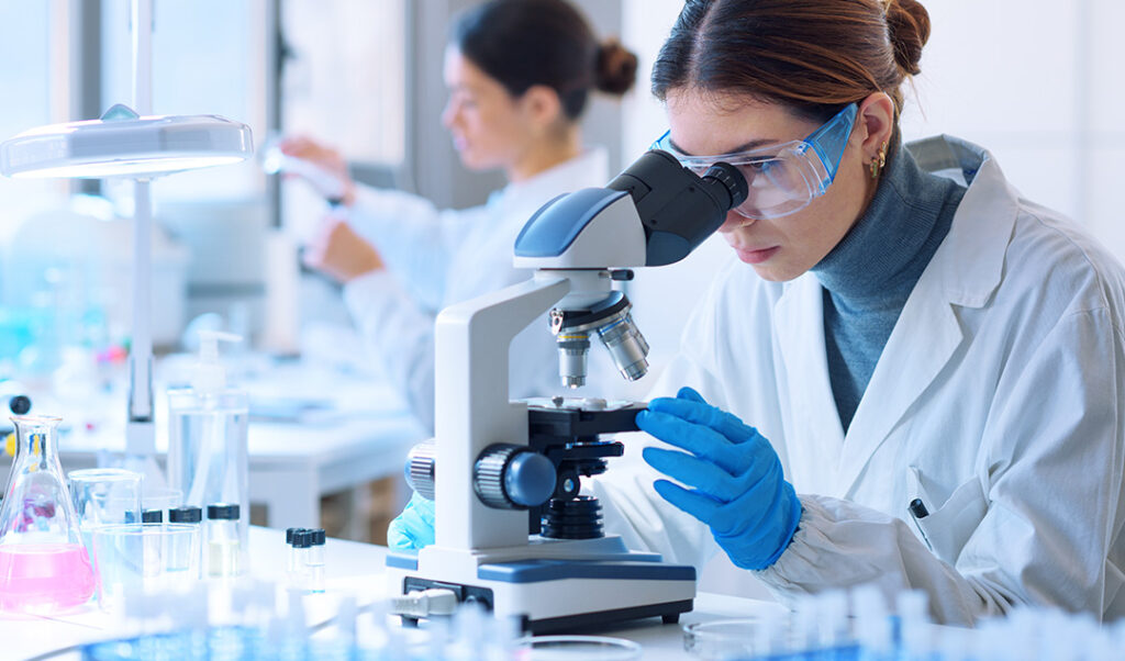 Researcher using microscope